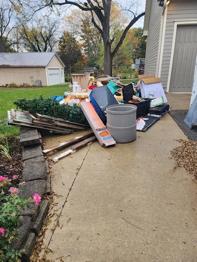 Dumpster being loaded with debris for 3 Yard Dumpster Rental in Boyne City